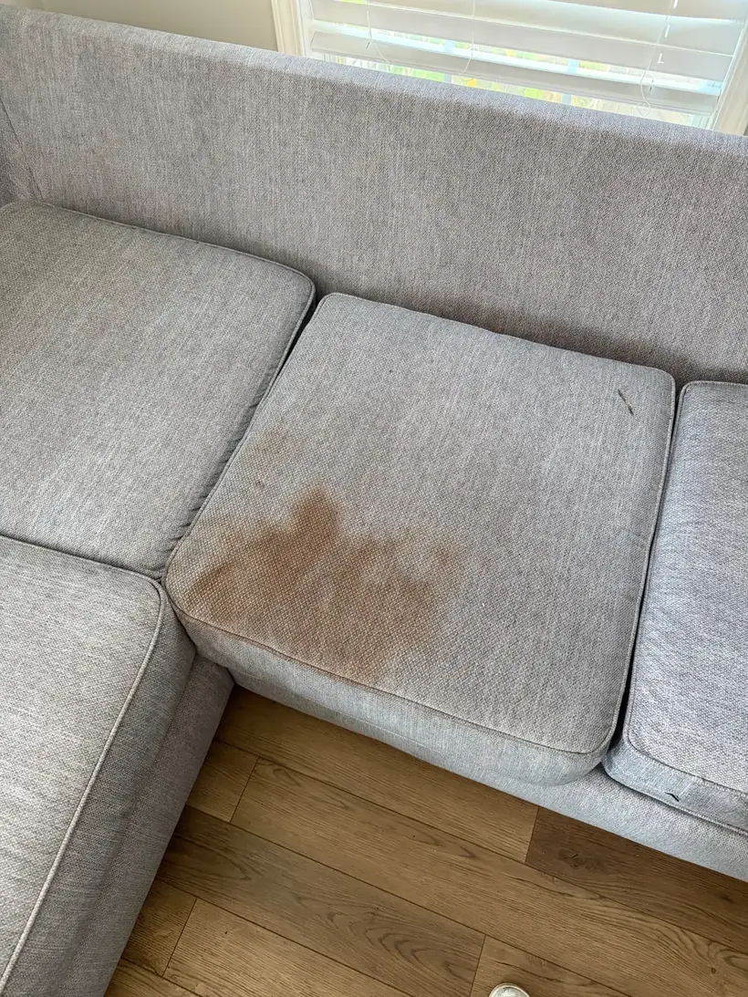 5-seat sectional with a large stain on the centre cushion before cleaning, Atlanta GA